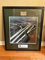 Full view of framed photograph standing on floor