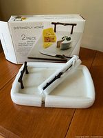 Box and contents showing marble board secured in foam with knife, brand and set name visible