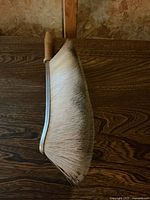 Overall view of bench brush showing wooden handle, metal spine and bristles