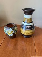 Both vases side by side on table