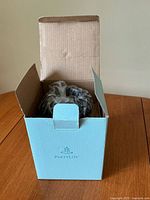 Closed PartyLite box with inner packaging visible