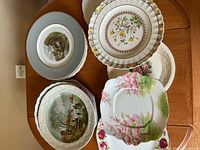 Top view of multiple stacked plates showing variety of patterns and shapes