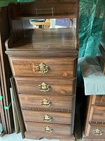 Full view of tall wood dresser showing mirror shelf and five drawers