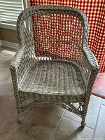 Front view showing overall design and condition of wicker armchair