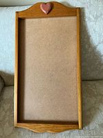 Front view of wooden calendar holder showing heart accent and recessed bay
