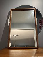 Front view showing full rectangular mirror within teak frame