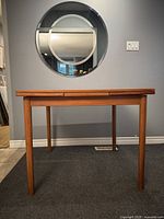 Front view of teak square dining table