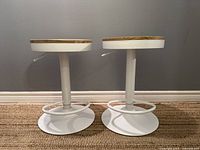 Front view of both bar stools showing seats and bases