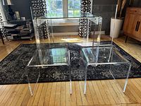 Front angled view of both clear Lucite chairs