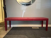 Front view of red vinyl bench showing full length and legs