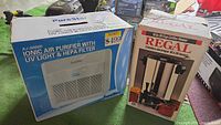 Boxed PureStar XJ-3000D air purifier and Regal 10-30 cup coffee percolator side by side