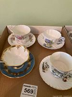 Tray containing four teacup and saucer sets