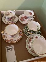 Tray with five teacup and saucer sets