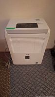 Front view of Arctic King dehumidifier with control panel and grill