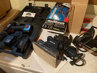 Jobmate drill kit, Mastercraft sander (loose and boxed), Craftsman jigsaw on table