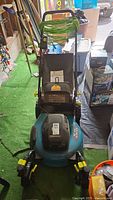 Front view of Yardworks electric mower with cord wrapped on handle