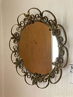 Full view of round mirror hanging on wall