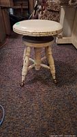 Full view of cream painted swivel piano stool