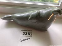 Full side view of soapstone walrus with MaxSold scale sticker
