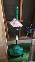 Full view of green Certified 12" electric snow thrower standing upright