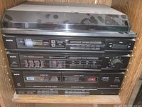 Front view of full Sanyo stereo stack showing turntable, tuner, equalizer, amplifier and cassette deck