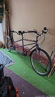 Full side view of purple Norco tandem bicycle