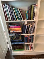 Four shelves filled with assorted books