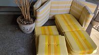 ceramic pot and assortment of yellow striped cushions