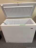 Chest freezer lid open showing exterior and interior