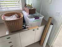 Overview of basket, tote bins, paper rolls on countertop
