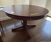 Full view of round wood pedestal dining table