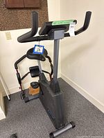 Full view of upright exercise bike and ab crunch trainer behind it
