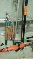 Hedge trimmer, packaged lopper, extension poles leaning