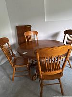 Round oak pedestal table with four matching chairs