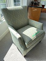 Front angled view of patterned lounge chair