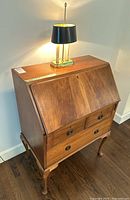 Front and side view of Queen Anne style secretaire desk with lamp on top
