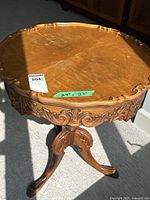 Full view of carved pedestal side table