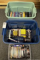 Three totes containing DVDs, VHS tapes and CDs