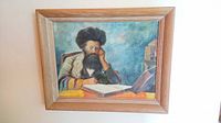 Front view of framed painting depicting seated man reading