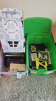 Two storage bins containing Build-A-Bear box and assorted board games visible