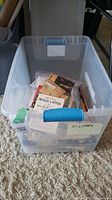 clear tote filled with books, magazines and stamp album