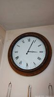 Full view of round wall clock on wall
