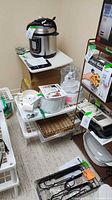Lot overview showing ice cream maker, accessories and plastic trays