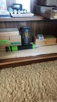 Shelf showing lantern, slide box, microscope box, air pump