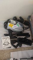 Steam cleaner with accessories and manual