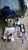 Lot overview on carpet showing trays, brushes, mitre box, zip ties, tools
