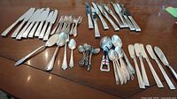 Overview of all flatware pieces laid out on table