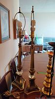 Full view of both metal table lamps standing on table