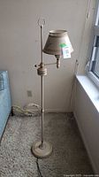 Full view of floor lamp showing height, base, shade and cord