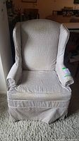 Front view of upholstered wingback chair